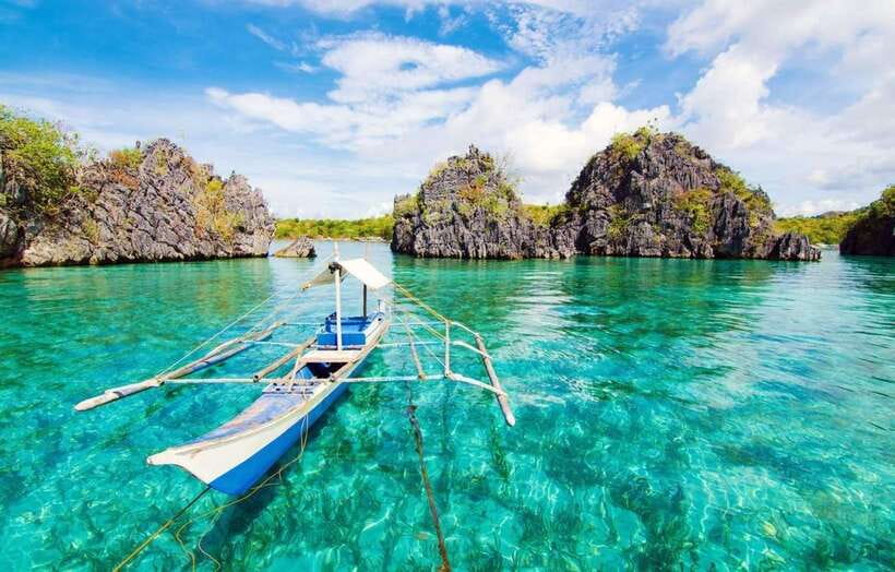 Coron: Coastal Cliffs, Beach & Malcapuya Island Hopping Tour - Setting out on a Philippine banca boat
